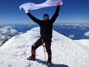 Taylor waving his company flag on the summit
