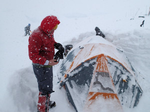 Kyle clearing snow from the tent